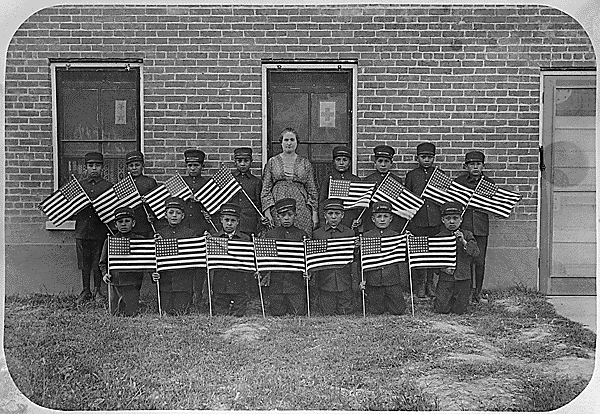 Class of young boys with flags, Albuquerque Indian School